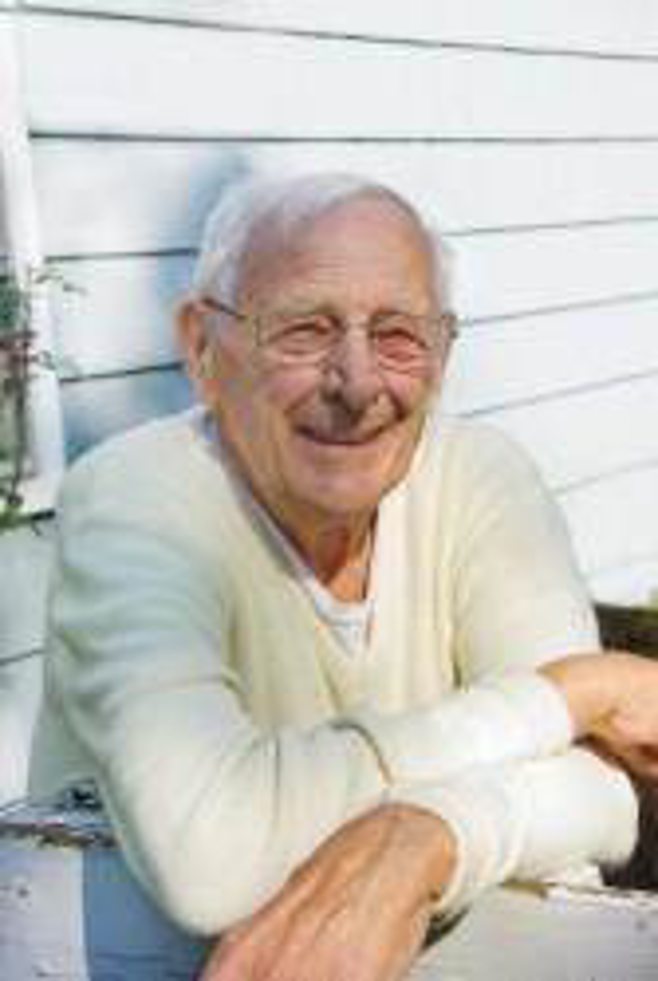 mans senior portrait smiling